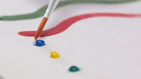 Close-up of painter's hands using brush and making painting strokes Stock Footage 130912009