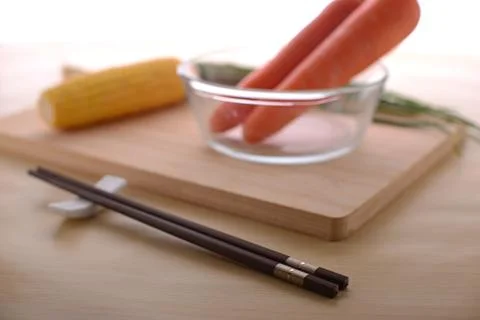 Close up on a pair of chopsticks with vegetables Stock Photos