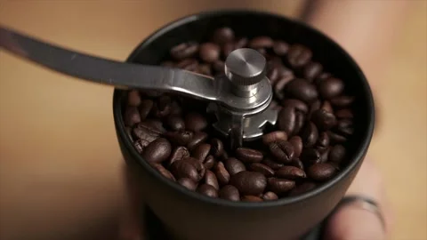 Close-up of a pair of hands grinding coffee beans using a manual coffee grinder Stock Footage 140752007