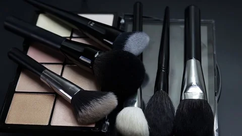Close-up of a palette of eyeshadows with brushes rotates. Stock Footage 127071503