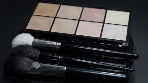 Close-up of a palette of eyeshadows with brushes rotates. Stock Footage 127071536