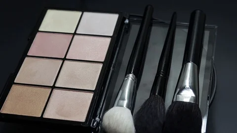 Close-up of a palette of eyeshadows with brushes rotates. Stock Footage 127102569