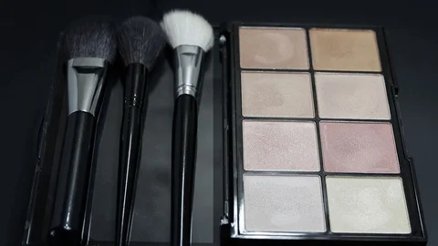 Close-up of a palette of eyeshadows with brushes rotates. Stock Footage 127102662