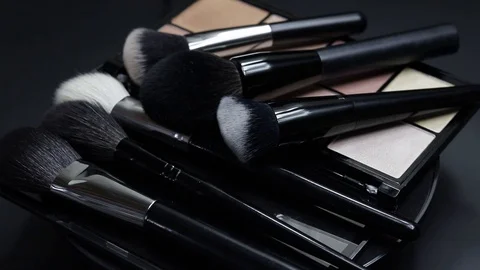 Close-up of a palette of eyeshadows with brushes rotates. Stock Footage 127102739