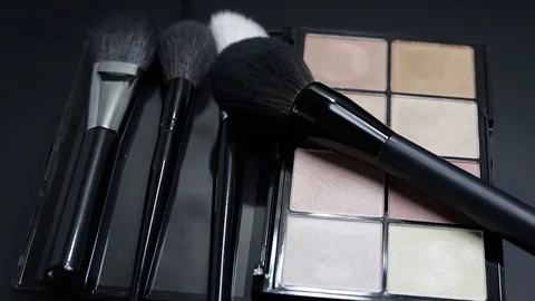 Close-up of a palette of eyeshadows with brushes rotates. Stock Footage 127102811