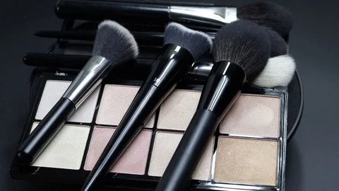 Close-up of a palette of eyeshadows with brushes rotates. Stock Footage 127102842