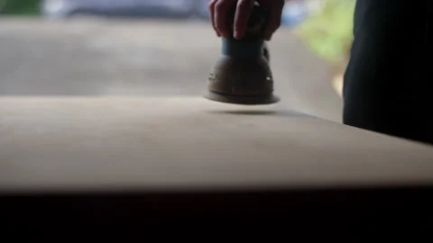 Close up of a palm sander getting used on a wooden table Video stock 134287345