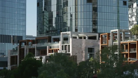 Close pan across base of various city skyscrapers Video stock 204060188