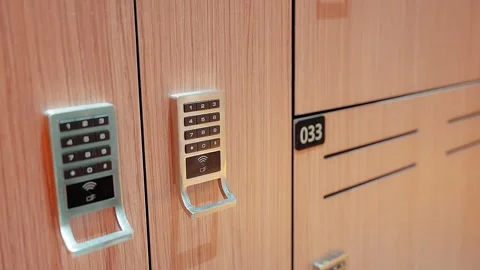 Close up pan electronic combination lock on gym locker door Video stock 342112121