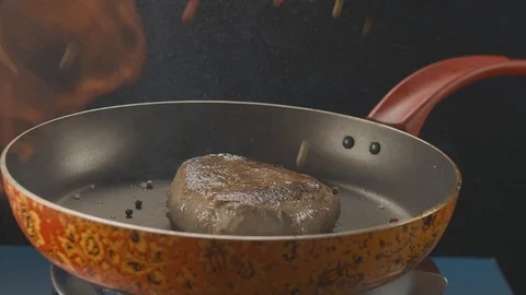 Close-up on the pan with grilled beef steak throw pepper with the effect of fire Stock Footage 112088141