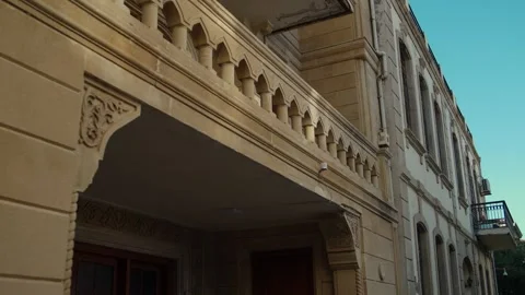 Close-up Pan of Historic Stone Building Facade with Ornate Balcony Stock Footage 338244556