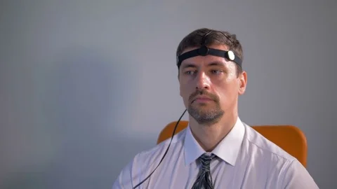 Close up pan of the man connected to the lie detector circuit. Stock Footage 77128699