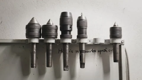 Close-up pan over a tray of heavy-duty industrial drill bits in a workshop 動画素材 331624556