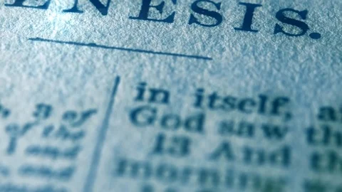 Close up pan on the page of Genesis in a Holy Bible Stock Footage