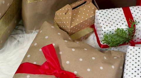Close up, pan of presents under the tree on christmas morning Stock Footage 43623523
