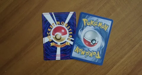 Close Up Pan Right of the Back of a Japanese and American Pokemon Card Stock Footage 311295216