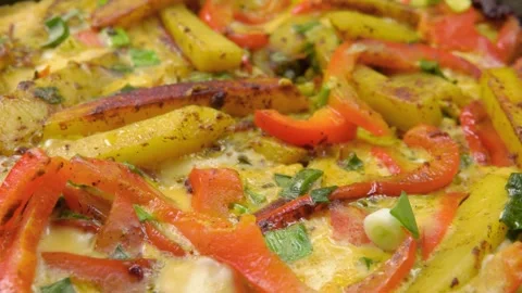 Close-up pan shot of a delicious rustic skillet frittata Stock Footage 328094390
