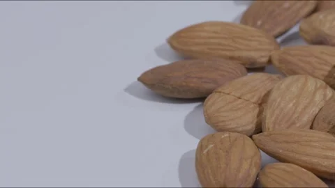 A close pan shot of dried almonds on a table Stock Footage 280339327