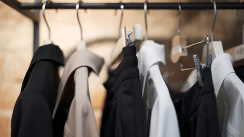Close up pan shot left to right of hangers with clothes Stock Footage 122374695
