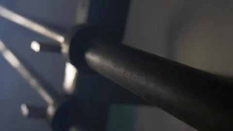 Close Up Of Pan Of Three Unloaded Barbells Lined Up On Squat Rack Stock Footage 123062658