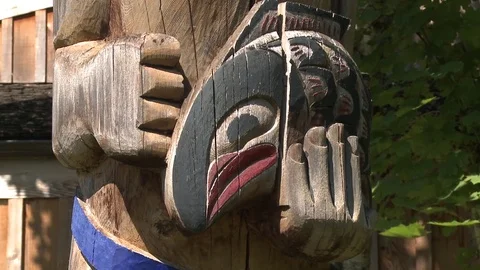 Close up pan of totem pole carving of a man with a large fish Stock Footage 75246398