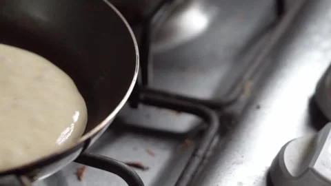 Close Up of Pancake Batter Cooking in Frying Pan Before Flipping on Stovetop Stock Footage 340801536