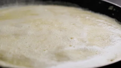 Close up of a pancake being baked pan to left slow motion  Stock Footage 169237408