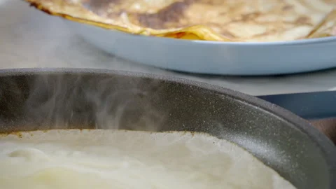 Close-up of a pancake, crepe being cooked. Slow motion footage 100fps. Stock Footage 305386239