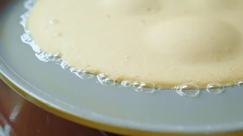 Close up of pancake fried in butter gray pan. Oil bubbles. Homemade Delicious. Stock Footage 127965944