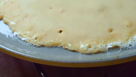 Close up of pancake fried in butter gray pan. Oil bubbles. Homemade Delicious. Stock Footage 128187076