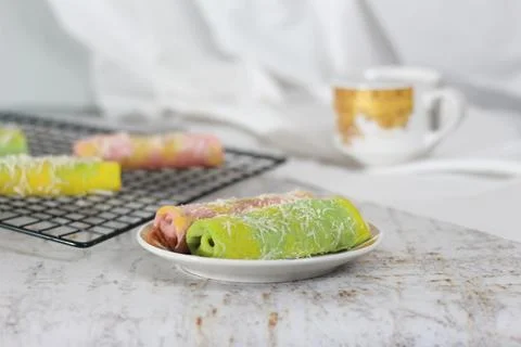A close up of pancake rolls or Dadar Gulung with a rainbow pattern ready to.. Stock Photos