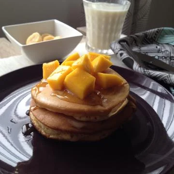 Close up pancake with topped mango Stock Photos