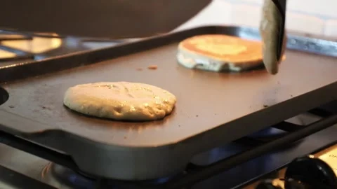 Close Up of Pancakes Being Flipped on Griddle for Family Breakfast 動画素材 346655193