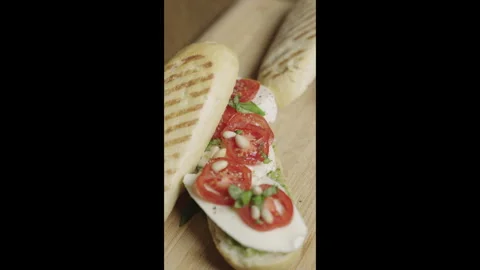 Close up of panini Caprese with mozzarella, tomatoes and basil pesto. Stock Footage 301926095