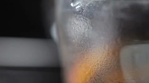 Close up panning of drops of hot tea in a glass cup Stock Footage 56353707