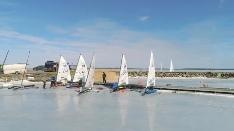 Close panning of ice boats preparing for race in harbour Stock Footage 88201015
