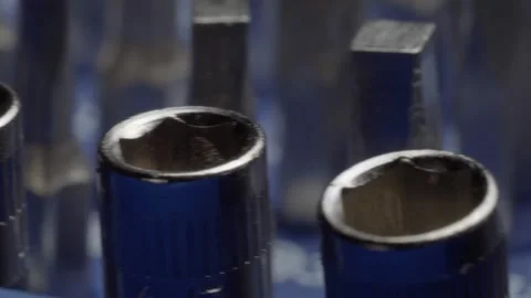 Close up panning over blue screwdriver kit components with metal tips and Vidéo 343710809
