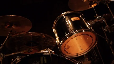 Close up panning shot of drum kit and guitar standing on stage Stock Footage 107628874