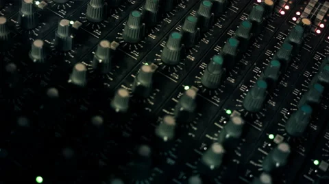 Close-up panning shot of EQ Knobs on a mixing console desk. Video stock 52056515