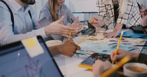 Close-up panning shot of multiethnic team meeting, brainstorming session behind Stock Footage 106155764