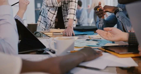 Close-up panning shot of multiethnic team meeting behind office table, woman Stock Footage 106156119