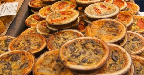 Close up panning view of a display of different variety of quiches Stock Footage 68985689