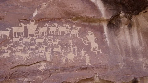 Close up panning view of The Great Hunt panel petroglyphs Stock Footage 108067070