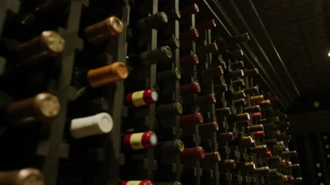 Close up panning on wine bottles in dark wine cellar Stock Footage 203996086