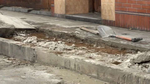 Close-up panning of workers removing remains of concrete from the sidewalk and 動画素材 160376821