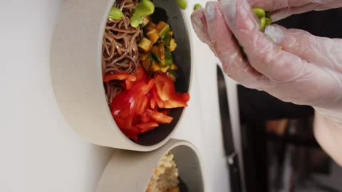 Close up pano of chief hands putting beans in Hawaiian Poke Bowl with different Vídeo Stock 168770552
