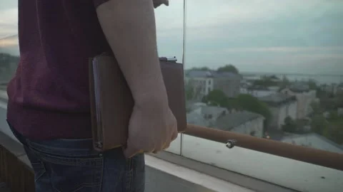 Close up panorama bird eye view on dark haired man standing on edge of roof look Stock Footage 132675497