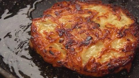 Close-up panorama of a potato pancake with a crispy crust frying in hot pan Stock Footage 234137042