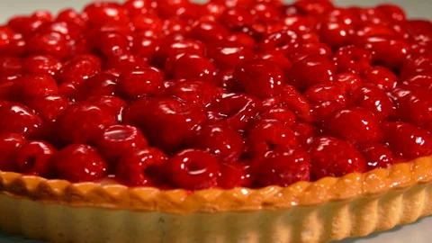 Close-up panorama of a red Fresh raspberry jelly-covered pie Stock Footage 172063735