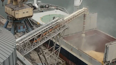 Close panorama of ship loading grain crops on bulk freighter via trunk to open Stock Footage 90433818